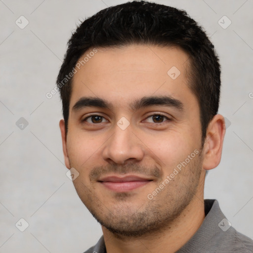 Joyful white young-adult male with short  black hair and brown eyes