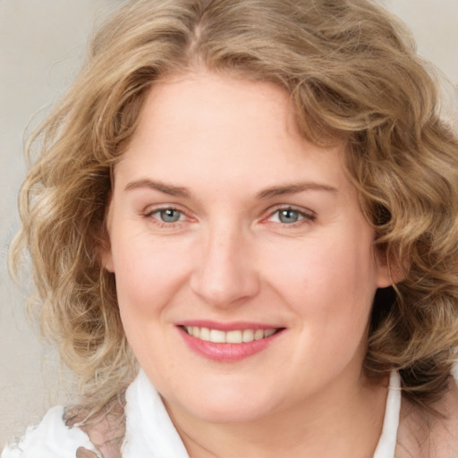 Joyful white adult female with medium  brown hair and blue eyes