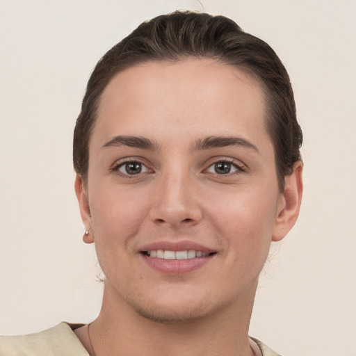 Joyful white young-adult female with short  brown hair and grey eyes