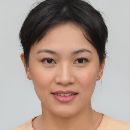 Joyful asian young-adult female with medium  brown hair and brown eyes