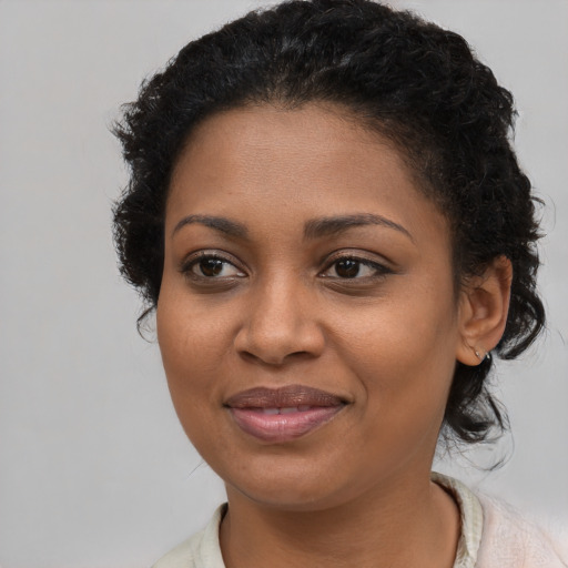 Joyful black young-adult female with short  brown hair and brown eyes