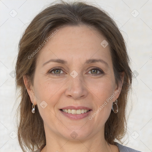 Joyful white adult female with medium  brown hair and grey eyes