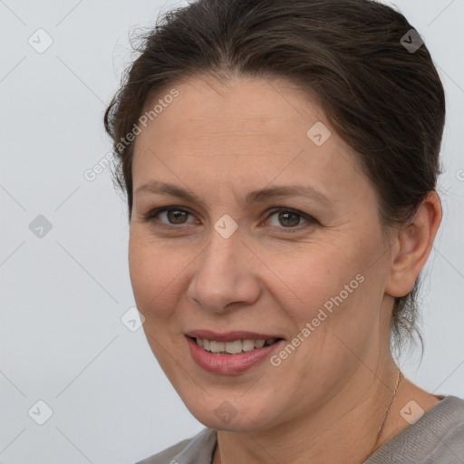 Joyful white adult female with medium  brown hair and brown eyes