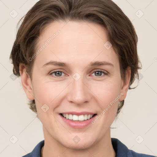 Joyful white young-adult female with medium  brown hair and grey eyes