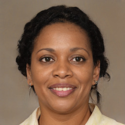 Joyful black adult female with medium  brown hair and brown eyes