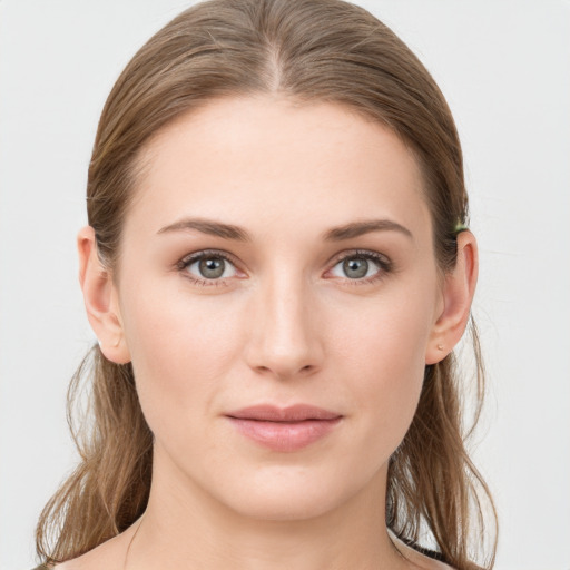 Joyful white young-adult female with medium  brown hair and grey eyes