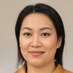 Joyful asian adult female with medium  brown hair and brown eyes