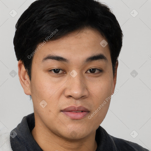 Joyful asian young-adult male with short  brown hair and brown eyes