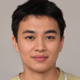 Joyful asian young-adult male with short  brown hair and brown eyes