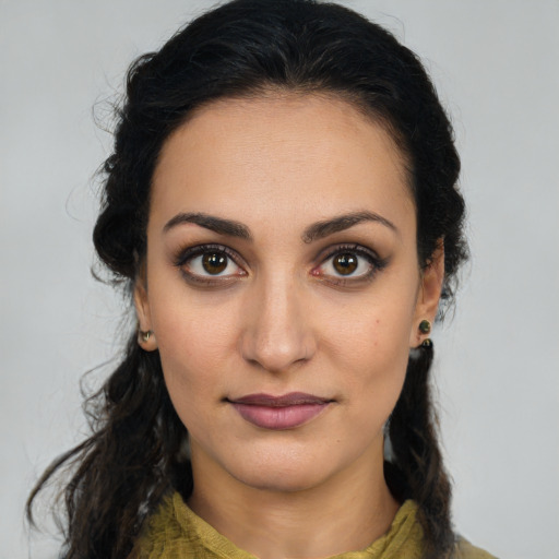 Joyful latino young-adult female with medium  brown hair and brown eyes