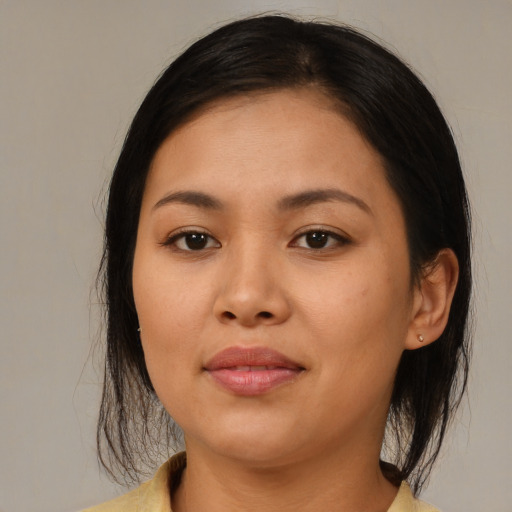 Joyful asian young-adult female with medium  brown hair and brown eyes