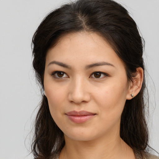 Joyful white young-adult female with long  brown hair and brown eyes