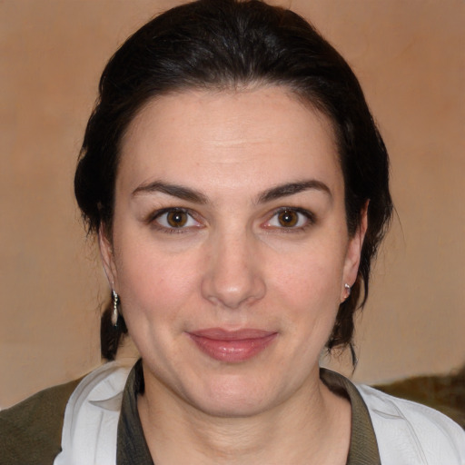 Joyful white adult female with medium  brown hair and brown eyes