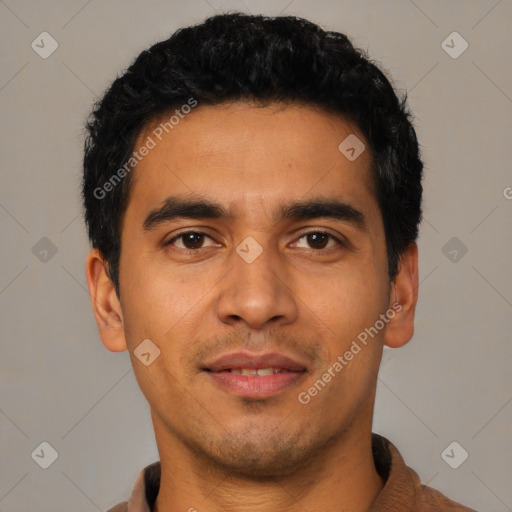 Joyful latino young-adult male with short  black hair and brown eyes