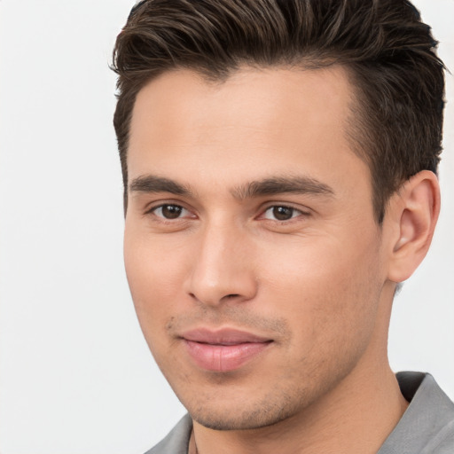 Joyful white young-adult male with short  brown hair and brown eyes