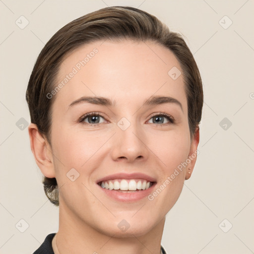 Joyful white young-adult female with short  brown hair and grey eyes