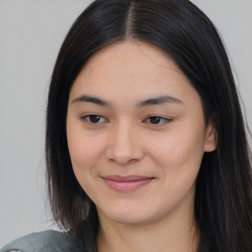 Joyful asian young-adult female with long  brown hair and brown eyes
