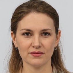 Joyful white young-adult female with long  brown hair and grey eyes