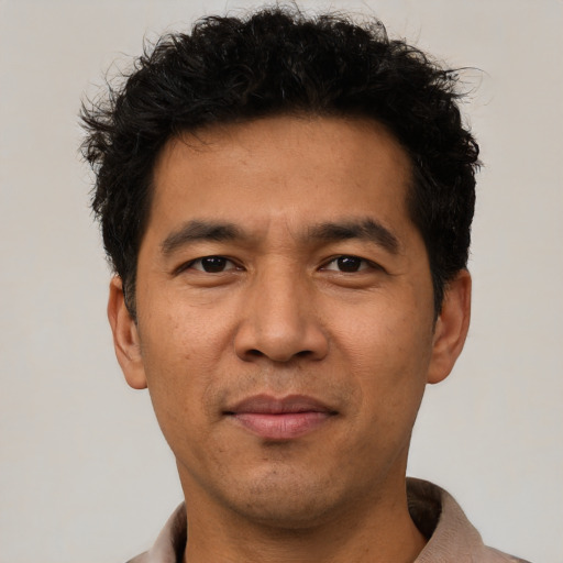 Joyful asian adult male with short  black hair and brown eyes
