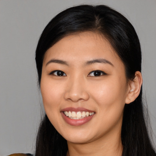 Joyful asian young-adult female with long  black hair and brown eyes