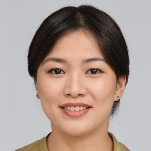 Joyful asian young-adult female with medium  brown hair and brown eyes