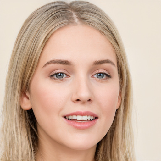 Joyful white young-adult female with long  brown hair and blue eyes