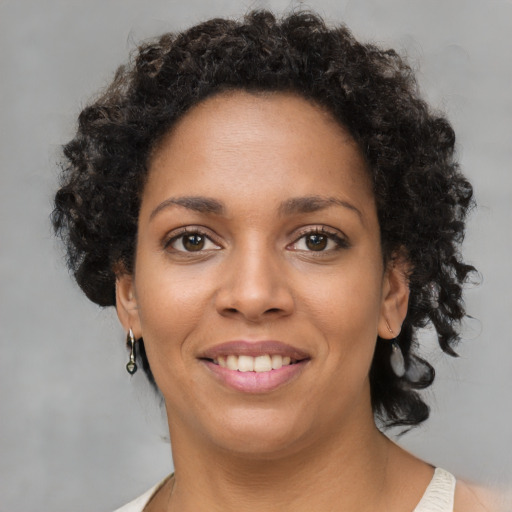 Joyful latino young-adult female with short  brown hair and brown eyes