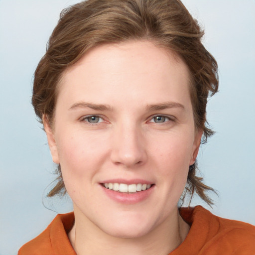 Joyful white young-adult female with medium  brown hair and blue eyes