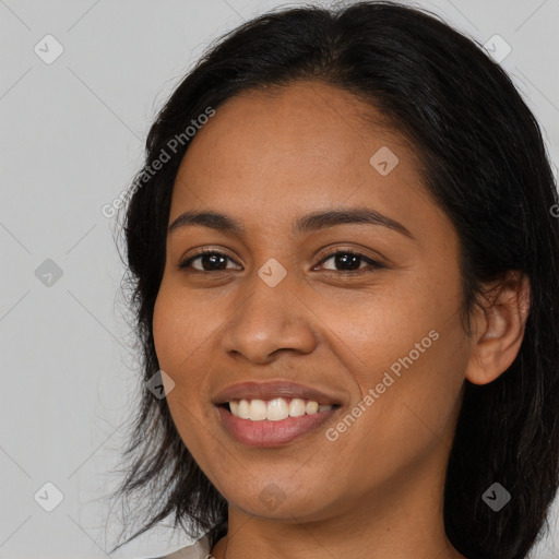 Joyful latino young-adult female with long  black hair and brown eyes