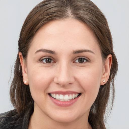 Joyful white young-adult female with medium  brown hair and brown eyes