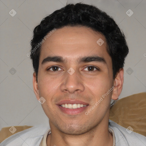 Joyful white young-adult male with short  black hair and brown eyes