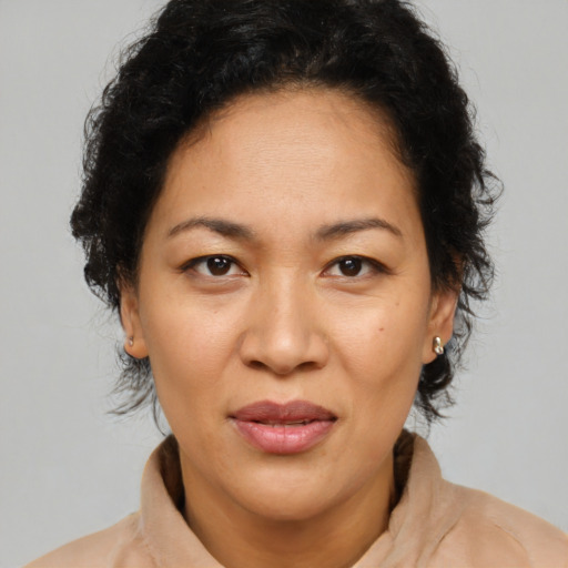 Joyful asian adult female with medium  brown hair and brown eyes