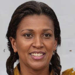 Joyful black adult female with medium  brown hair and brown eyes