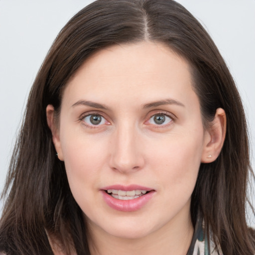 Joyful white young-adult female with long  brown hair and grey eyes