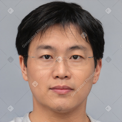 Joyful asian adult male with short  brown hair and brown eyes