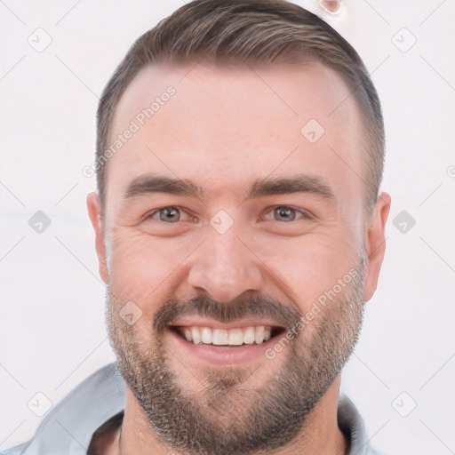 Joyful white adult male with short  brown hair and brown eyes