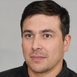 Joyful white adult male with short  brown hair and brown eyes