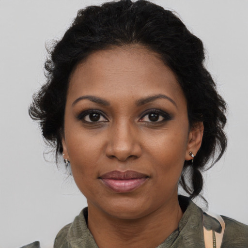 Joyful black adult female with medium  black hair and brown eyes