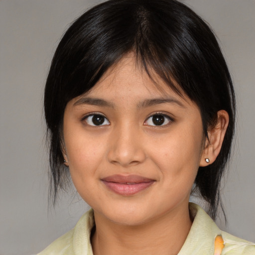 Joyful latino young-adult female with medium  brown hair and brown eyes