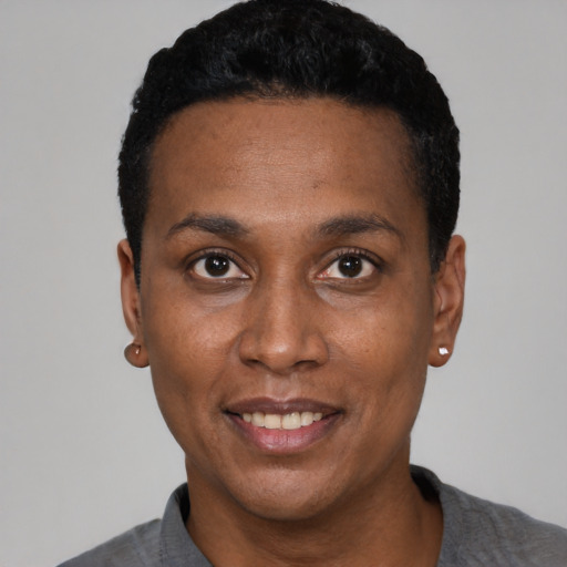 Joyful black adult female with short  black hair and brown eyes