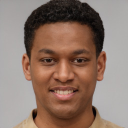 Joyful latino young-adult male with short  brown hair and brown eyes