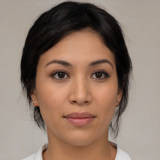 Joyful asian young-adult female with medium  black hair and brown eyes