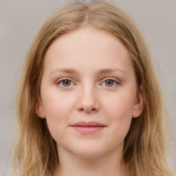 Joyful white young-adult female with long  brown hair and blue eyes