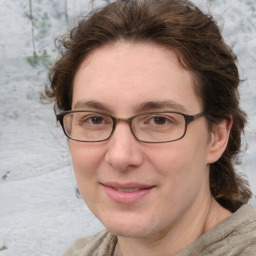 Joyful white adult female with medium  brown hair and blue eyes