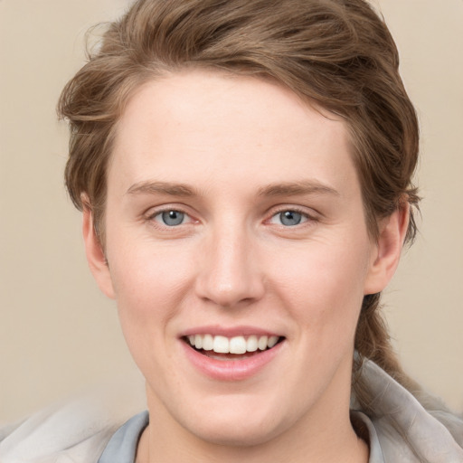 Joyful white young-adult female with medium  brown hair and blue eyes