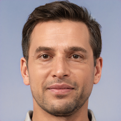 Joyful white adult male with short  brown hair and brown eyes