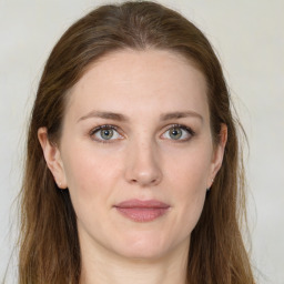 Joyful white young-adult female with long  brown hair and green eyes