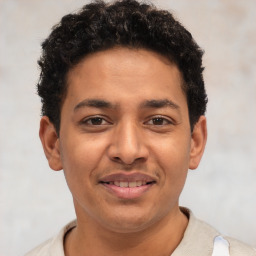 Joyful latino young-adult male with short  brown hair and brown eyes