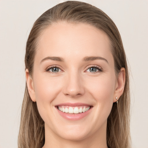 Joyful white young-adult female with long  brown hair and grey eyes