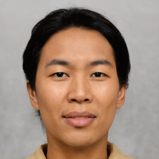 Joyful asian young-adult male with short  black hair and brown eyes